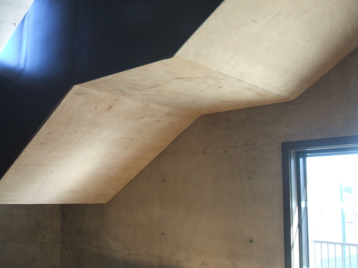 Exposed concrete staircase soffit with skylight detail