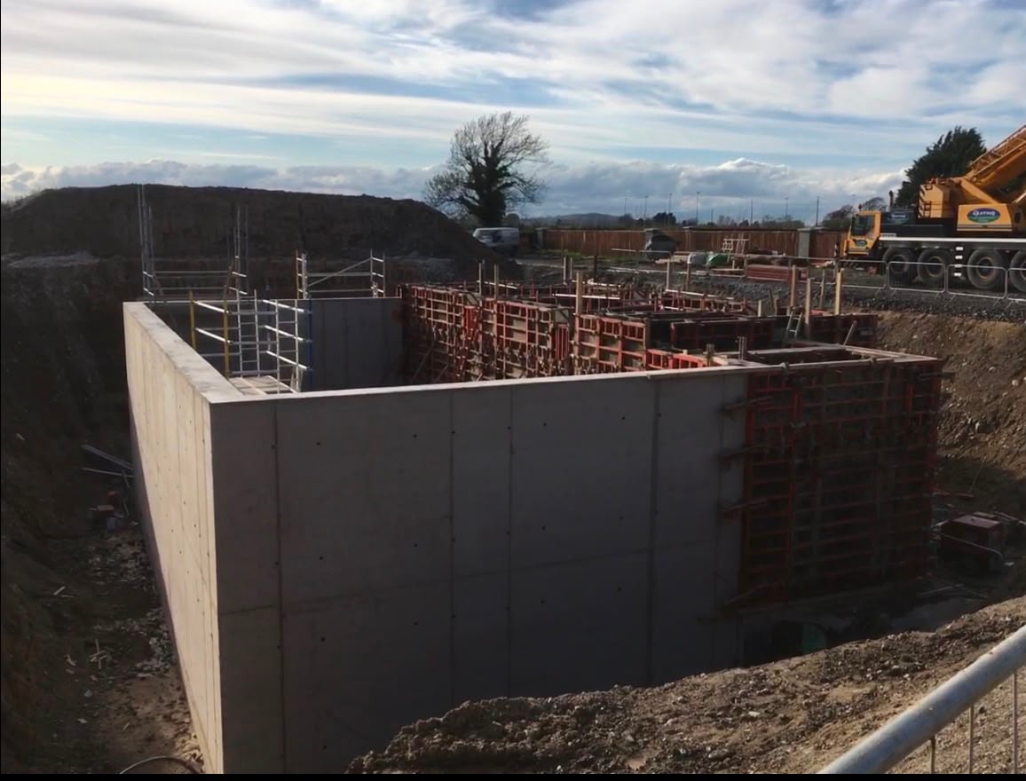 Concrete foundation slab with rebar walls under construction
